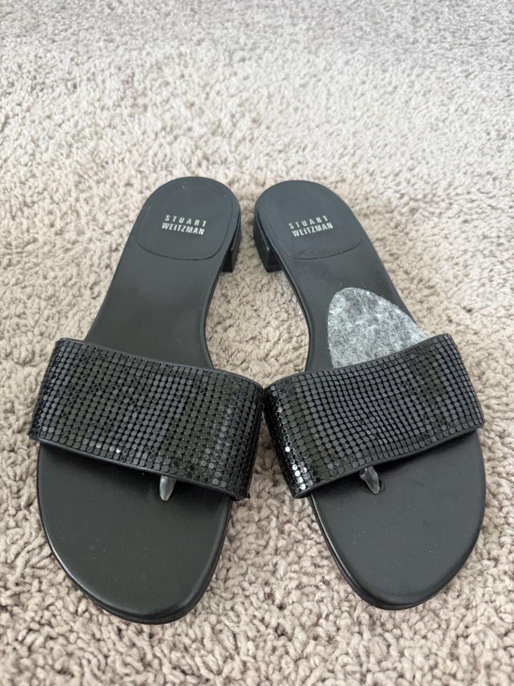 Stuart Weitzman crystal-embellished flat thong sandals in black leather.
